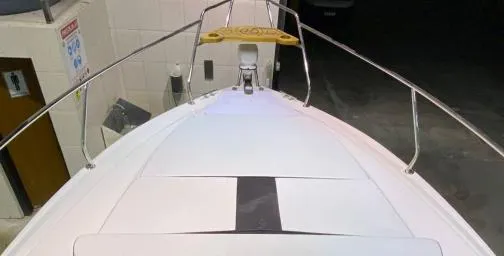 Slide: The Image of 2025 Hanover 305 Outboard Black & White T-Top Edition boat, viewed from the bow. - 5