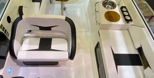 Slide: The Image of 2025 Hanover 305 Outboard Black & White T-Top Edition interior with seating and sink. - 6
