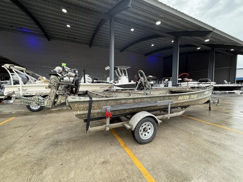 Slide: The Image of 2005 Gator Trax 18 boat on trailer in covered parking area. - 3