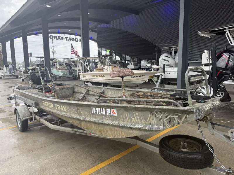 Slide: The Image of 2005 Gator Trax 18 boat on trailer at dealership, surrounded by other boats. - 5