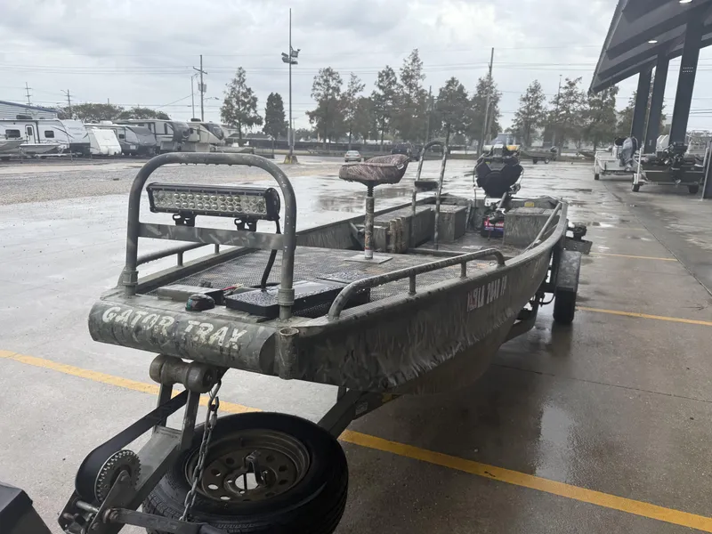 Slide: The Image of 2005 Gator Trax 18 boat on trailer in parking lot, overcast day. - 6