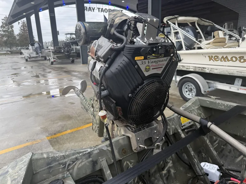 Slide: The Image of Gator Trax 18 boat with Vanguard 35 HyperDrive engine, parked at a boat yard. - 7