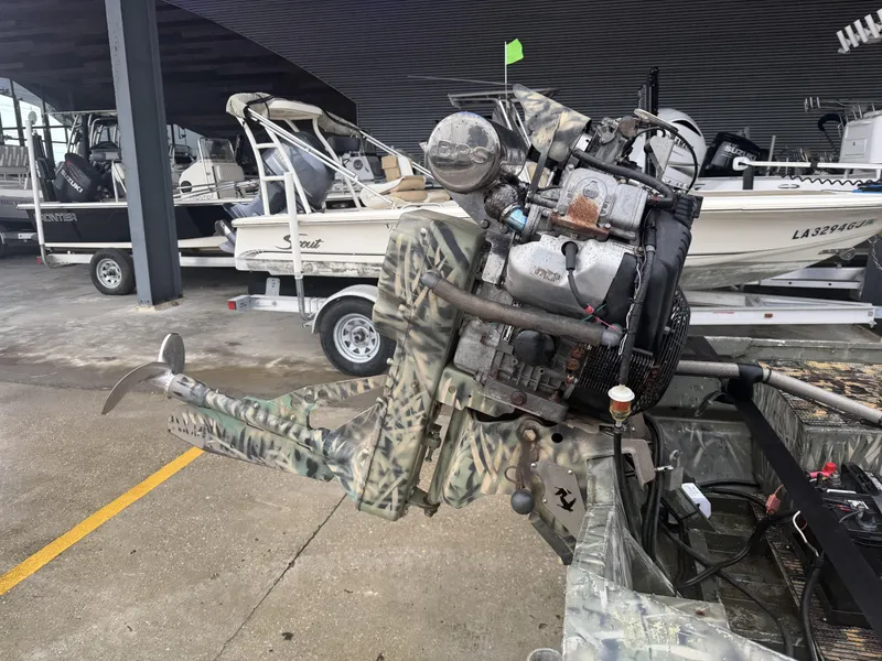Slide: The Image of Camouflaged Gator Trax 18 boat motor, 2005 model, in a marina setting. - 8