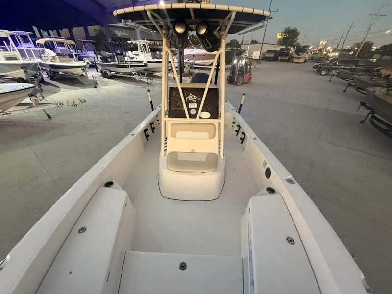 Slide: The Image of 2013 BlackJack 224 boat in a showroom, surrounded by other boats. - 17