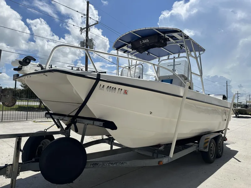 Slide: The Image of 2005 Twin Vee 22 boat on trailer under a sunny sky. - 10