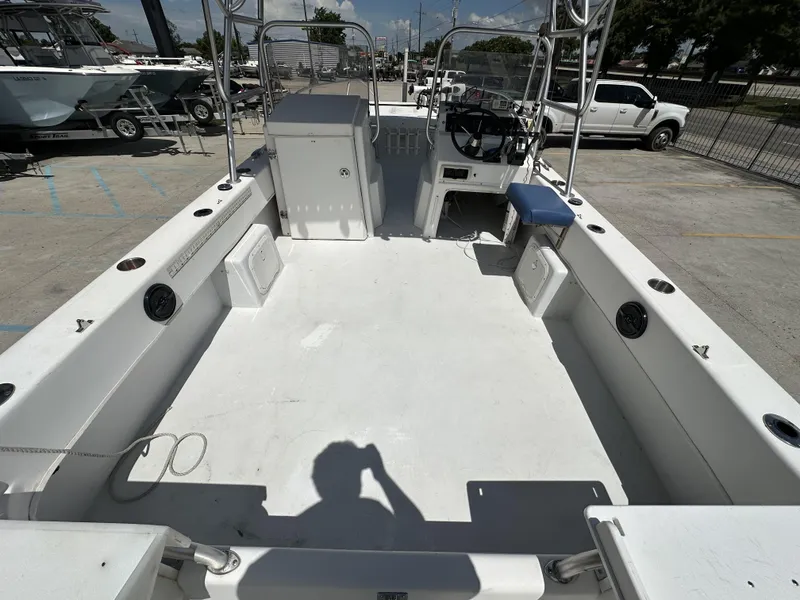 Slide: The Image of 2005 Twin Vee 22 boat interior, featuring spacious deck and steering console. - 11