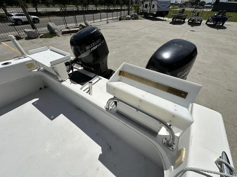Slide: The Image of 2005 Twin Vee 22 boat with dual Suzuki outboard motors in a parking area. - 12