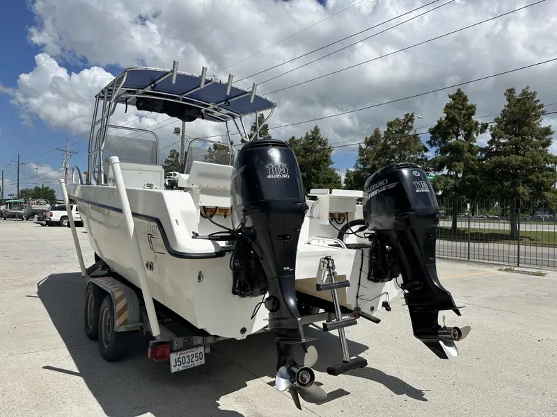 Slide: The Image of 2005 Twin Vee 22 boat with dual Suzuki 115 outboard motors on a trailer. - 3