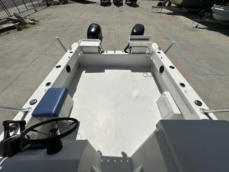 Slide: The Image of 2005 Twin Vee 22 boat interior with dual outboard motors, spacious deck, and steering console. - 5