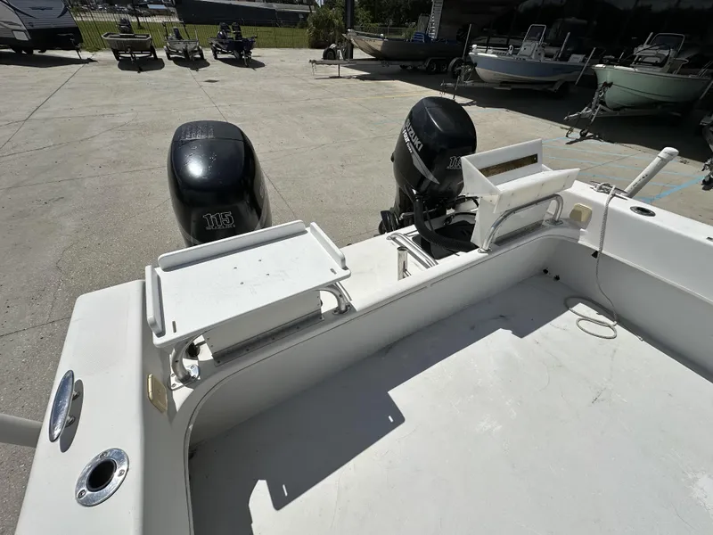 Slide: The Image of 2005 Twin Vee 22 boat with dual outboard motors in a parking area. - 6