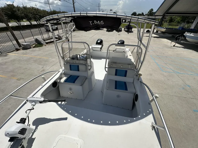 Slide: The Image of 2005 Twin Vee 22 boat with dual seating and T-top, parked on concrete. - 8