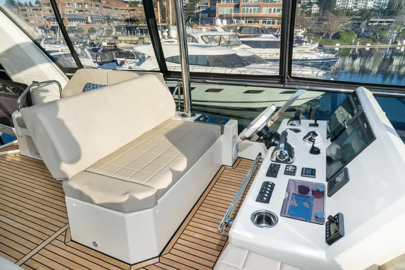 Slide: The Image of Helm station of 2018 Prestige 630 yacht with modern controls and seating. - 14