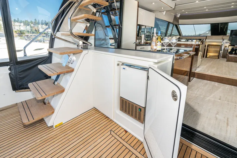 Slide: The Image of Luxury interior of 2018 Prestige 630 yacht with wooden stairs and open mini-fridge. - 26