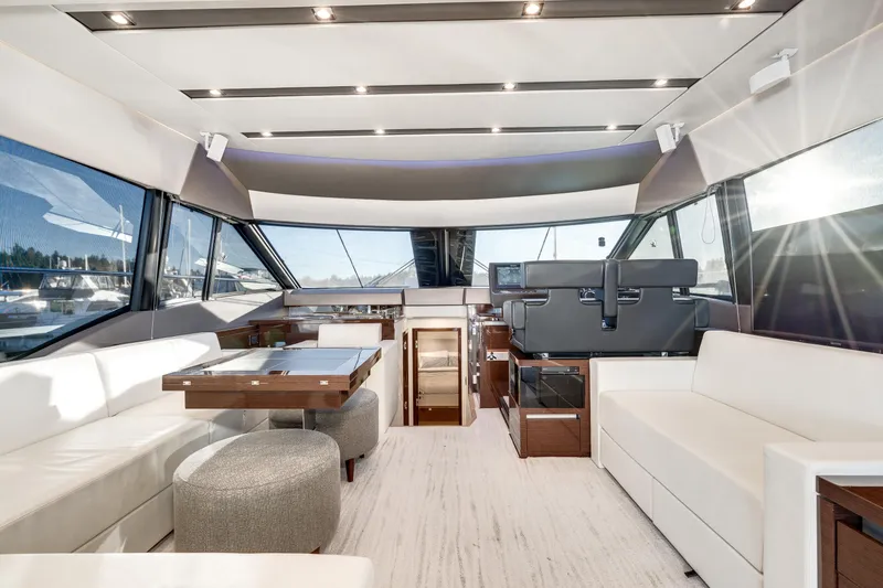 Slide: The Image of Luxurious interior of 2018 Prestige 630 yacht with modern seating and panoramic windows. - 33