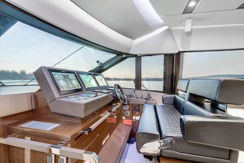 Slide: The Image of Luxurious 2018 Prestige 630 yacht interior with modern navigation controls and leather seating. - 34