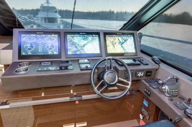 Slide: The Image of Cockpit of 2018 Prestige 630 yacht with advanced navigation displays and controls. - 36