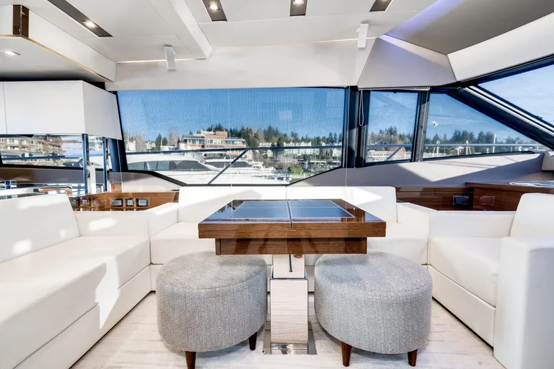 Slide: The Image of Luxurious interior of a 2018 Prestige 630 yacht with modern seating and panoramic windows. - 37