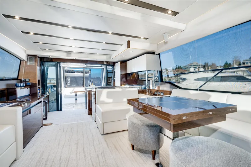 Slide: The Image of Luxurious interior of a 2018 Prestige 630 yacht with modern furnishings and panoramic windows. - 38