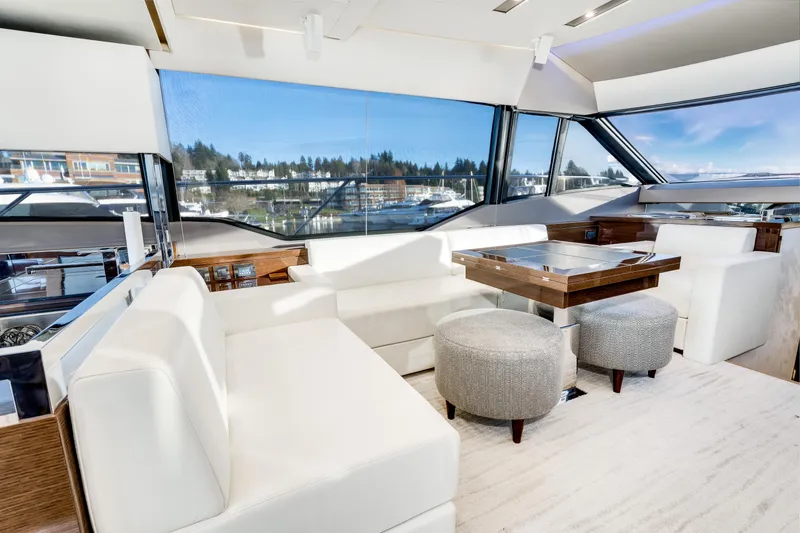 Slide: The Image of Luxurious interior of a 2018 Prestige 630 yacht with white seating and panoramic windows. - 41