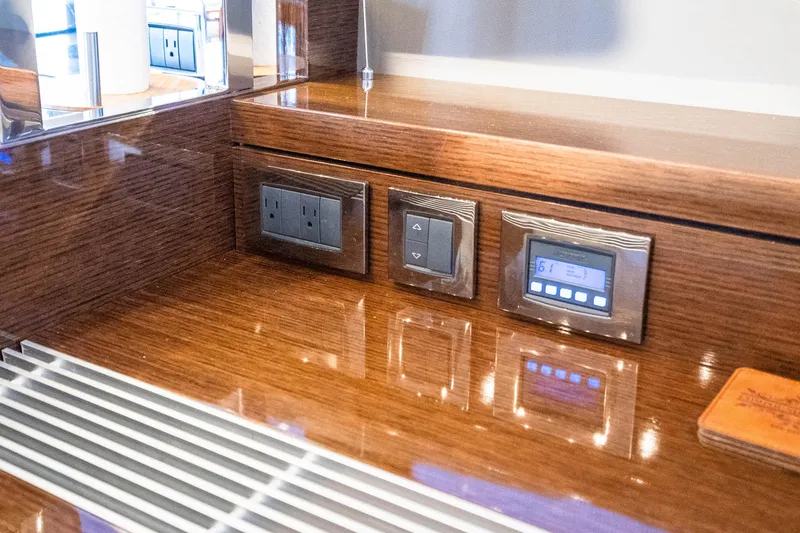 Slide: The Image of Control panel on a 2018 Prestige 630 yacht with wood finish and modern switches. - 42
