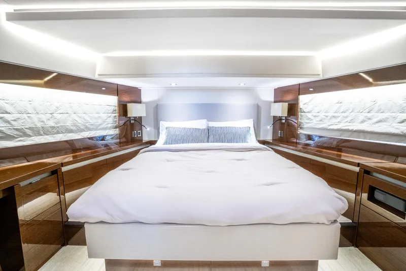 Slide: The Image of Luxurious bedroom interior of a 2018 Prestige 630 yacht, featuring modern design and ambient lighting. - 44