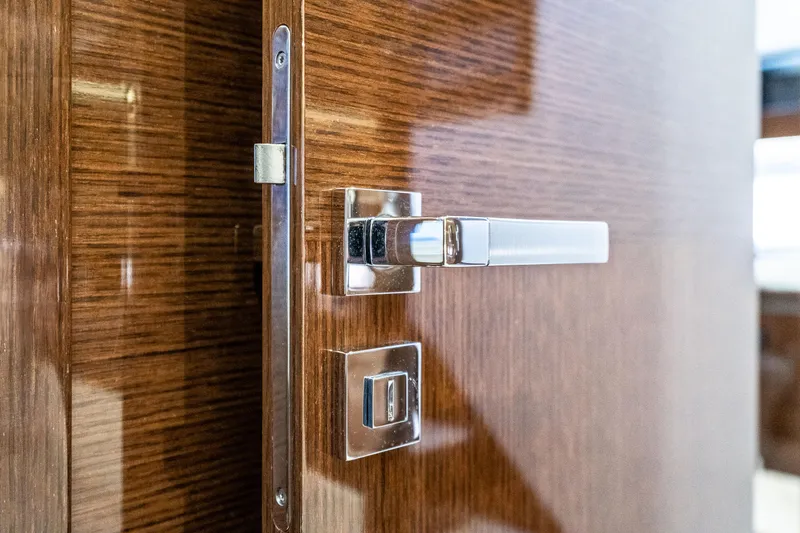 Slide: The Image of Sleek wooden door with modern chrome handle on a 2018 Prestige 630 yacht. - 55