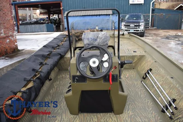 Slide: The Image of 2023 Tracker GRIZZLY® 2072 CC boat interior with steering console and camo design. - 11