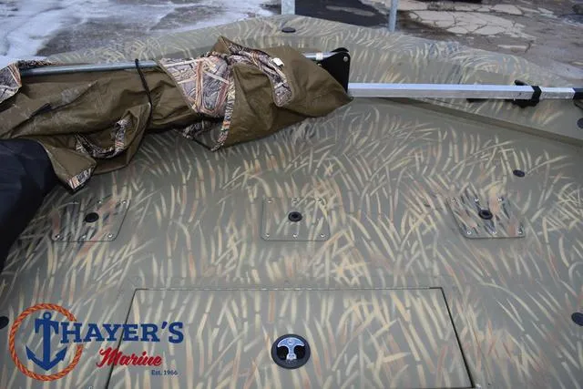 Slide: The Image of 2023 Tracker GRIZZLY® 2072 CC boat with camouflage pattern, Thayer's Marine logo visible. - 14