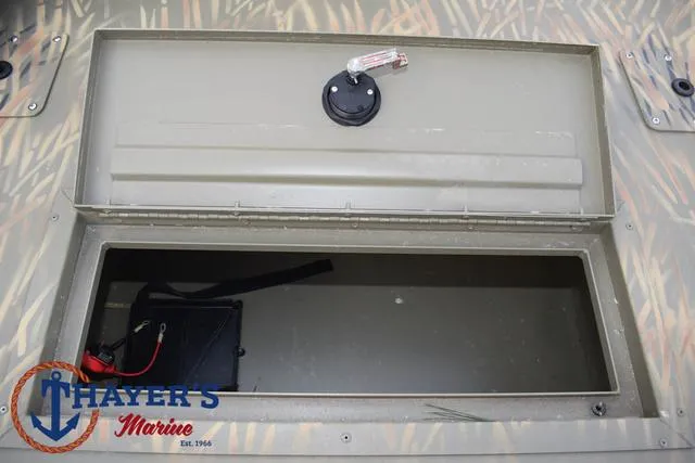 Slide: The Image of 2023 Tracker GRIZZLY® 2072 CC storage compartment, Thayer's Marine logo visible. - 15