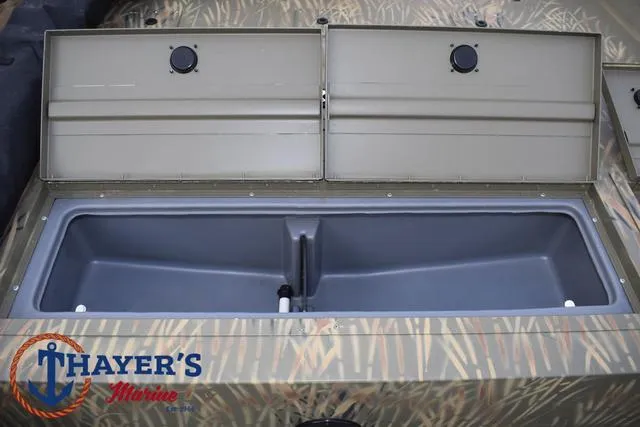Slide: The Image of 2023 Tracker GRIZZLY® 2072 CC boat storage compartment, open with camouflage design. - 16