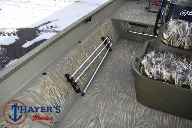 Slide: The Image of 2023 Tracker GRIZZLY® 2072 CC boat interior with camo seats and rod holders, Thayer's Marine logo. - 21
