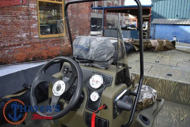 Slide: The Image of 2023 Tracker GRIZZLY® 2072 CC boat interior with steering wheel and gauges. - 22