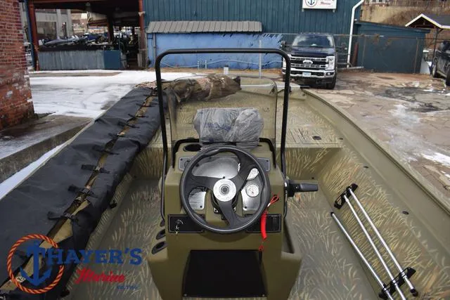 Slide: The Image of 2023 Tracker GRIZZLY® 2072 CC boat interior with steering wheel and controls. - 30