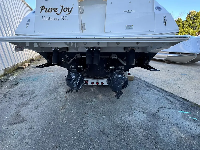 Slide: The Image of 2008 Fountain 38 Sportfish Express Cruiser rear view, docked, with "Pure Joy" name visible. - 11