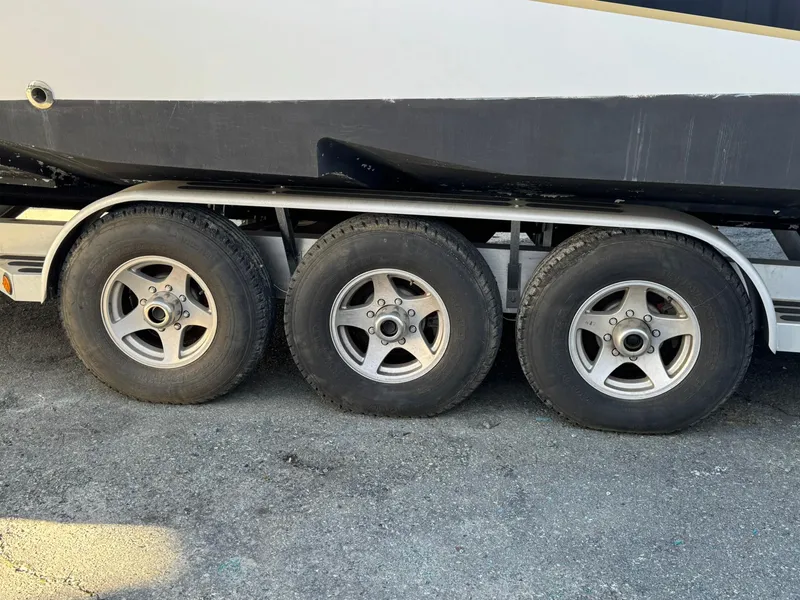 Slide: The Image of Trailer wheels of a 2008 Fountain 38 Sportfish Express Cruiser on pavement. - 14