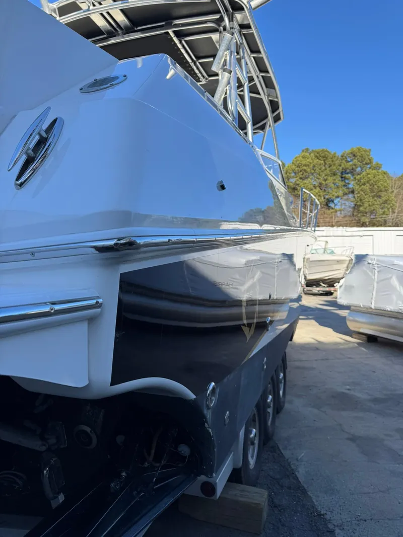 Slide: The Image of 2008 Fountain 38 Sportfish Express Cruiser, docked, showcasing sleek design and triple-axle trailer. - 15