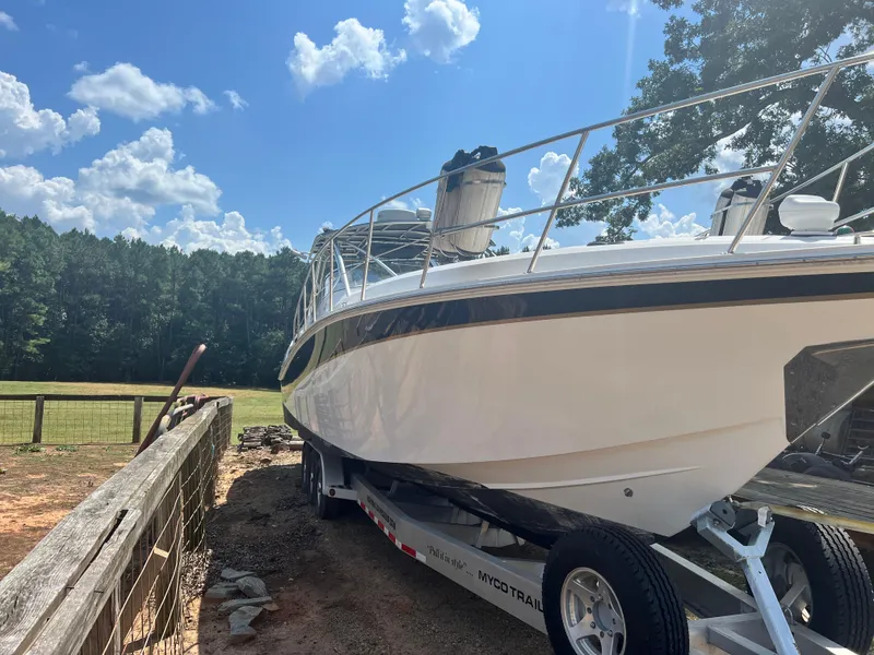 Slide: The Image of 2008 Fountain 38 Sportfish Express Cruiser on trailer, parked outdoors under a blue sky. - 2