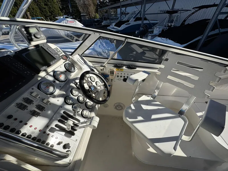 Slide: The Image of 2008 Fountain 38 Sportfish Express Cruiser cockpit with steering wheel and control panel. - 22