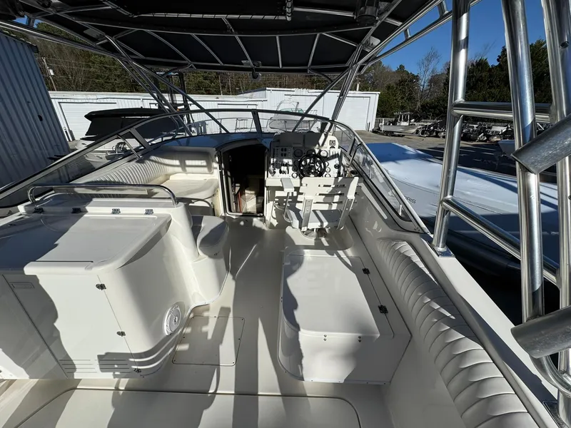 Slide: The Image of 2008 Fountain 38 Sportfish Express Cruiser interior with seating and helm, under a canopy. - 25