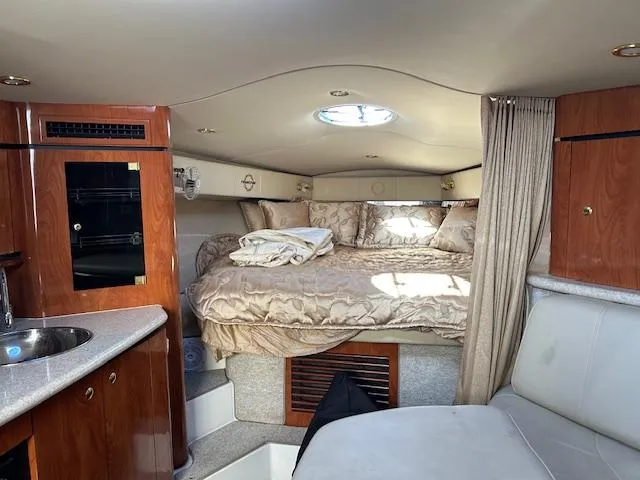 Slide: The Image of Interior of 2008 Fountain 38 Sportfish Express Cruiser with cozy bed and wood cabinetry. - 26