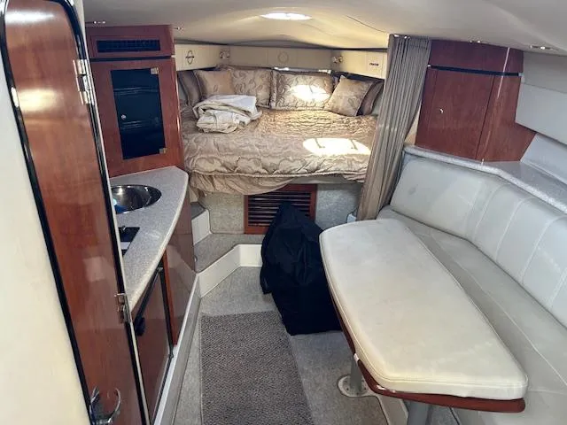 Slide: The Image of 2008 Fountain 38 Sportfish Express Cruiser interior with bed, kitchenette, and seating area. - 27