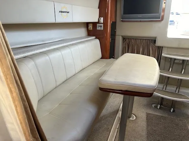 Slide: The Image of Interior of 2008 Fountain 38 Sportfish Express Cruiser with seating, table, and TV. - 31