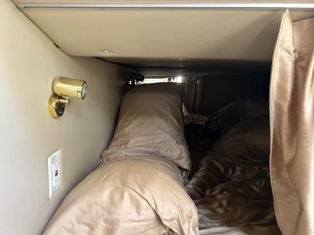 Slide: The Image of Interior cabin of 2008 Fountain 38 Sportfish Express Cruiser with bedding and reading light. - 37