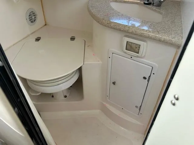 Slide: The Image of 2008 Fountain 38 Sportfish Express Cruiser bathroom with toilet and sink. - 38