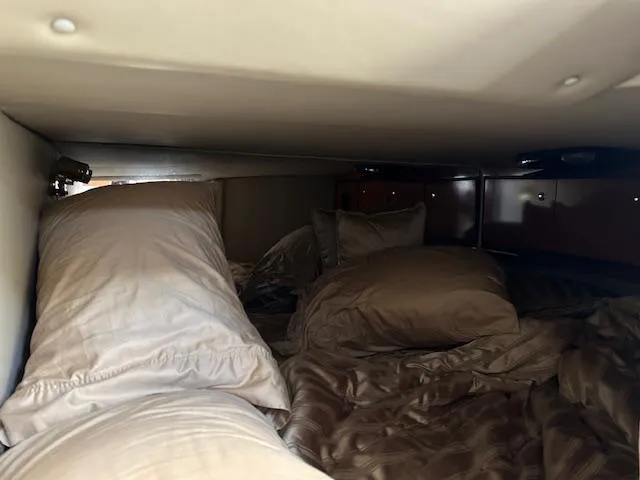 Slide: The Image of Interior cabin of 2008 Fountain 38 Sportfish Express Cruiser with cozy bedding. - 39