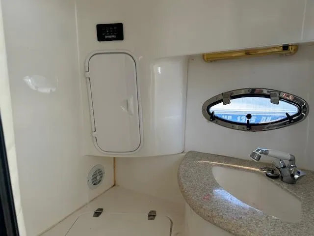 Slide: The Image of 2008 Fountain 38 Sportfish Express Cruiser bathroom with sink and porthole window. - 40
