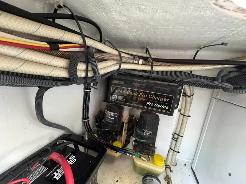 Slide: The Image of Engine compartment of 2008 Fountain 38 Sportfish Express Cruiser with wiring and battery charger. - 44