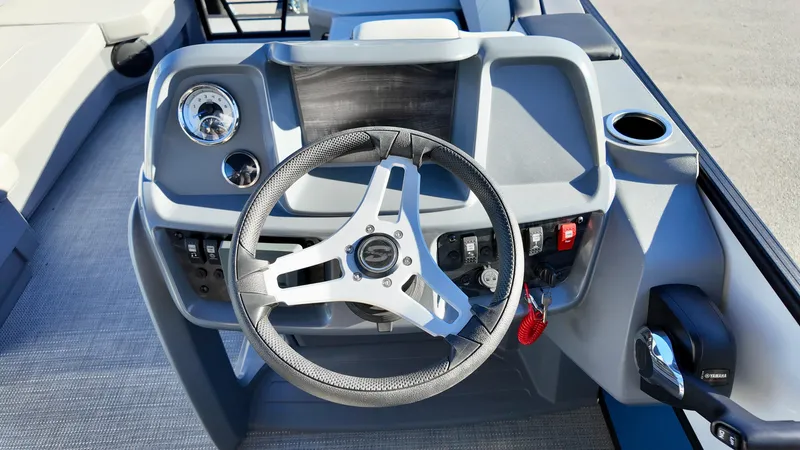 Slide: The Image of Steering console of 2025 Sylvan A-Series A20 LZ DH boat, featuring modern controls and design. - 14