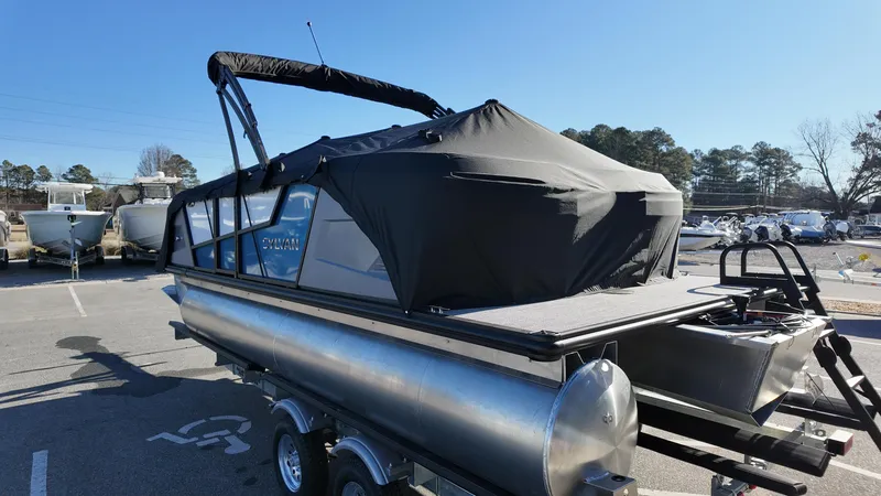 Slide: The Image of 2025 Sylvan A-Series A20 LZ DH pontoon boat with black canopy on trailer. - 17