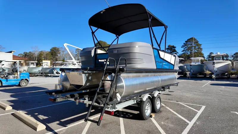 Slide: The Image of 2025 Sylvan A-Series A20 LZ DH pontoon boat on trailer in parking lot. - 4
